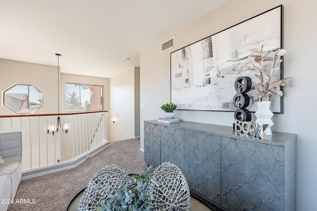 interior space with a notable chandelier and carpet floors