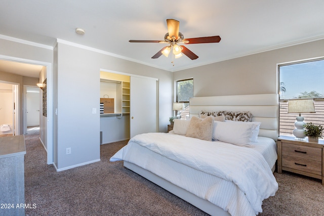 carpeted bedroom featuring crown molding, a closet, and ceiling fan