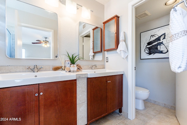 bathroom with toilet, vanity, tile patterned floors, and ceiling fan