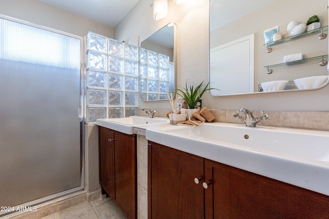 bathroom with vanity, tile patterned flooring, and a shower with door