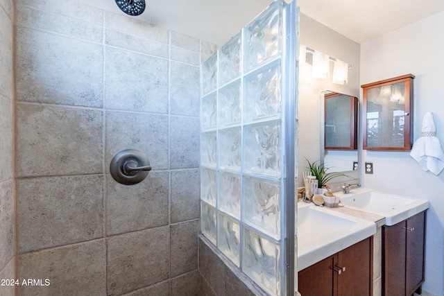 bathroom with vanity and a tile shower