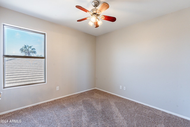 carpeted empty room featuring ceiling fan