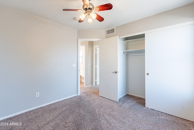 unfurnished bedroom with light carpet, a closet, and ceiling fan