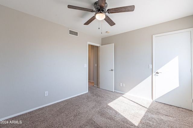 unfurnished bedroom featuring light colored carpet and ceiling fan