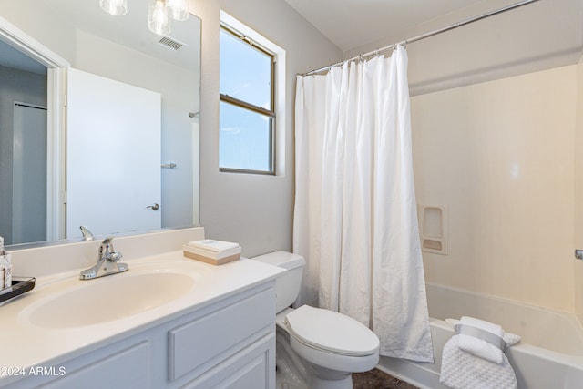 full bathroom with vanity, shower / tub combo, and toilet