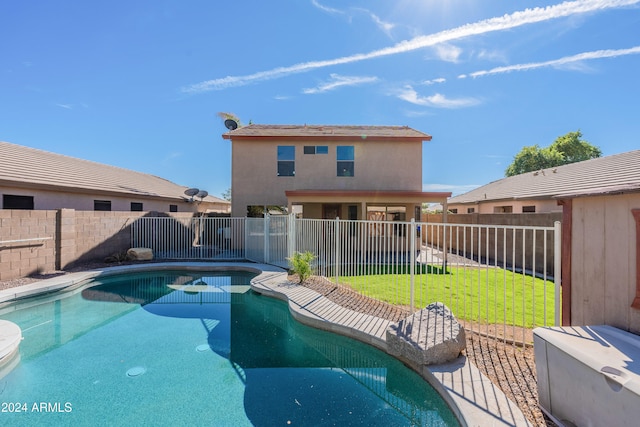 view of pool featuring a lawn