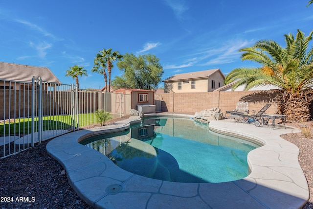 view of pool featuring a storage shed and a patio area