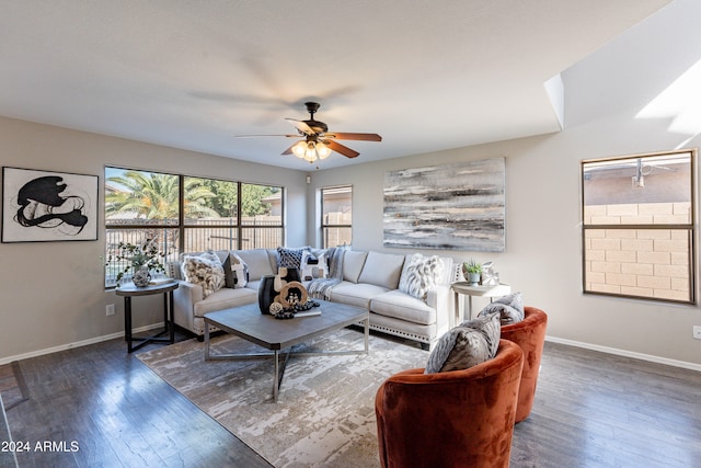 living room with ceiling fan and dark hardwood / wood-style flooring