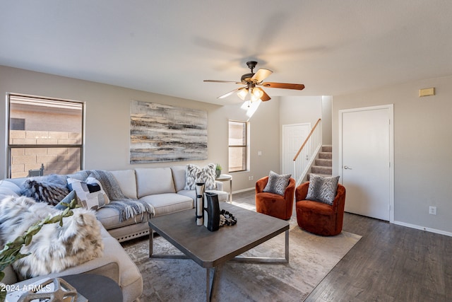 living room with ceiling fan and dark hardwood / wood-style flooring