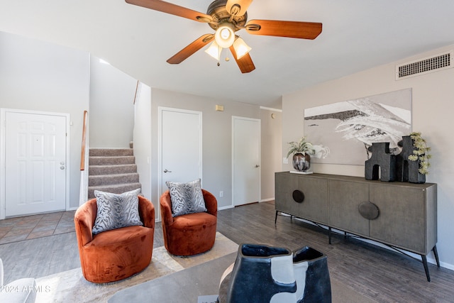 sitting room featuring ceiling fan and dark hardwood / wood-style floors