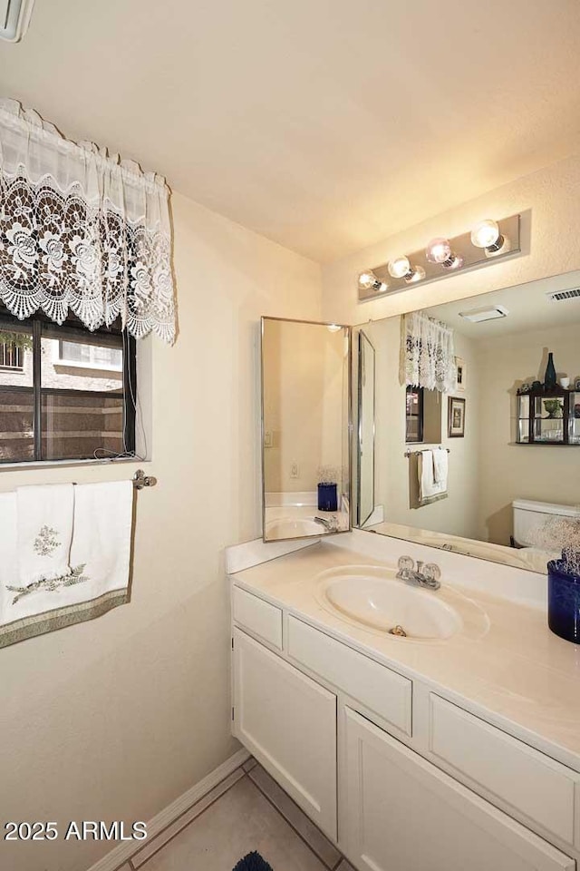 bathroom featuring tile patterned floors, visible vents, and vanity