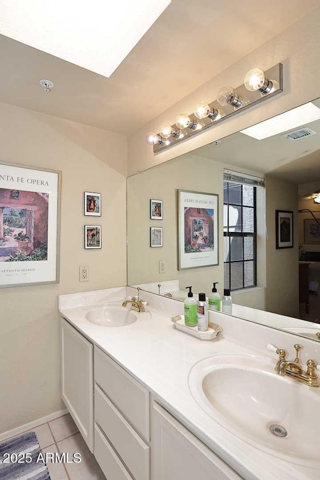 full bathroom featuring double vanity, visible vents, a sink, and tile patterned flooring