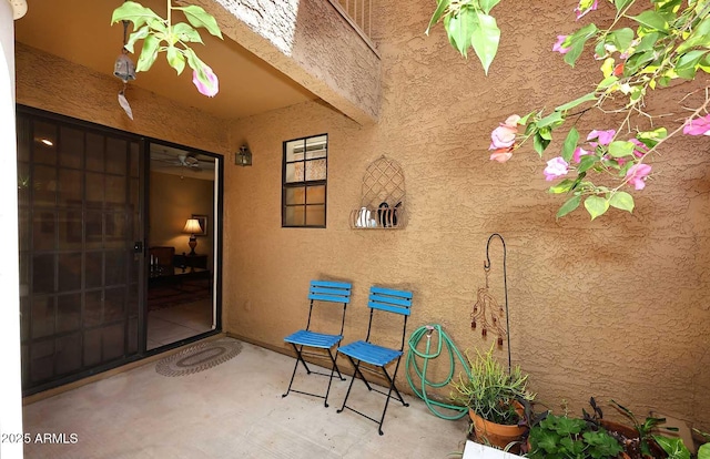 doorway to property with a patio area and stucco siding