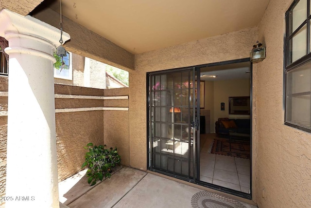 doorway to property featuring stucco siding