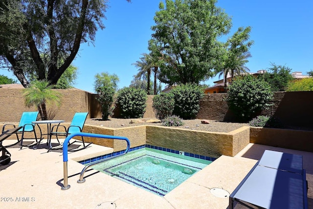 view of pool featuring a fenced backyard, an in ground hot tub, and a patio area