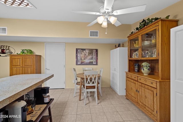 dining space featuring light tile patterned floors and ceiling fan