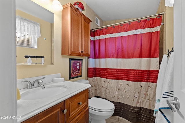 bathroom featuring tile patterned flooring, a shower with curtain, vanity, and toilet