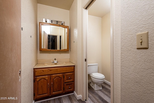 2995 W Rd 1 S, Chino Valley, AZ 86323 - bathroom with a textured wall, wood finished floors, vanity, and toilet