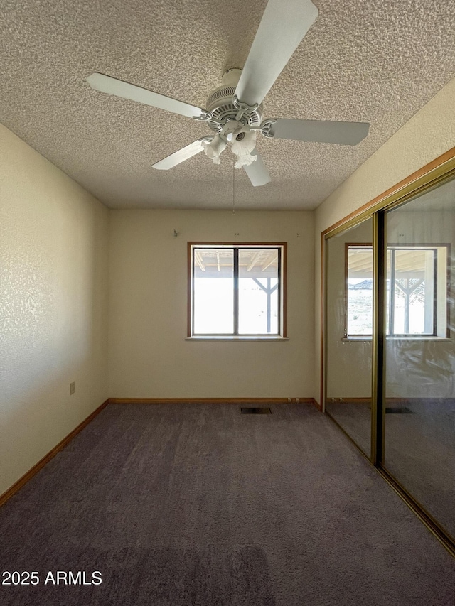 2995 W Rd 1 S, Chino Valley, AZ 86323 - unfurnished bedroom featuring a closet, carpet, a textured ceiling, and visible vents