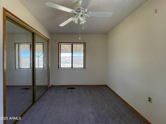 2995 W Rd 1 S, Chino Valley, AZ 86323 - unfurnished bedroom featuring a textured ceiling, visible vents, baseboards, carpet, and a closet