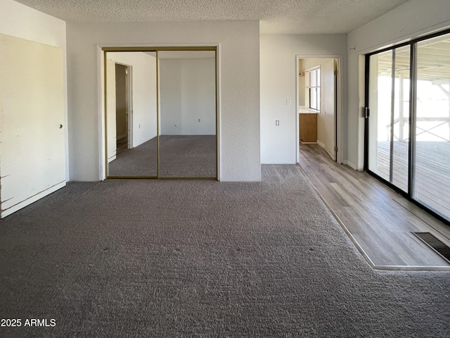 2995 W Rd 1 S, Chino Valley, AZ 86323 - unfurnished bedroom featuring visible vents, access to outside, and a textured ceiling