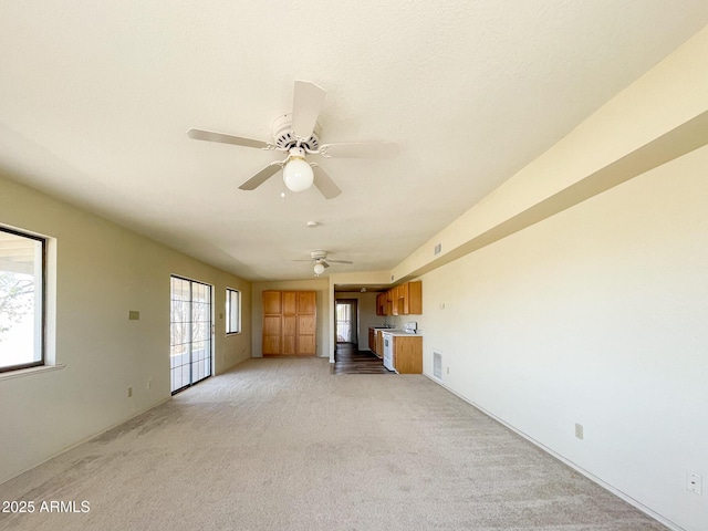 2995 W Rd 1 S, Chino Valley, AZ 86323 - unfurnished living room with light colored carpet, a ceiling fan, and visible vents
