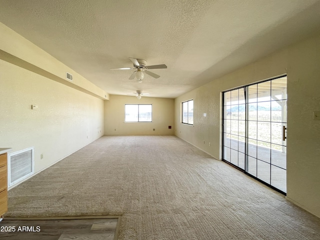 2995 W Rd 1 S, Chino Valley, AZ 86323 - carpeted spare room with a textured ceiling, visible vents, and a ceiling fan