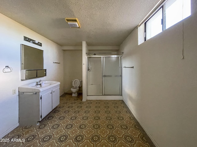 2995 W Rd 1 S, Chino Valley, AZ 86323 - full bathroom featuring an enclosed shower, toilet, vanity, baseboards, and a textured ceiling