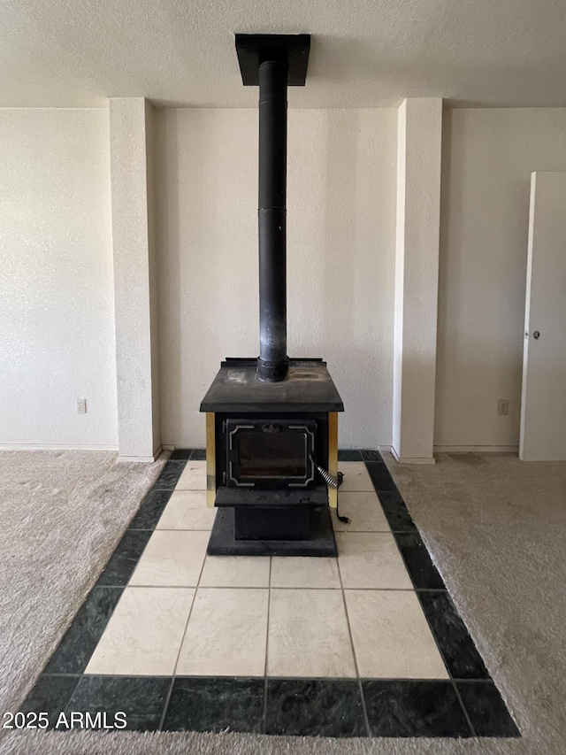 2995 W Rd 1 S, Chino Valley, AZ 86323 - room details featuring a wood stove, carpet flooring, and a textured ceiling