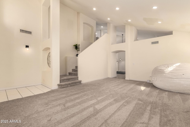 1421 E Charleston Ave, Phoenix, AZ 85022 - unfurnished living room with carpet floors, high vaulted ceiling, recessed lighting, stairs, and arched walkways