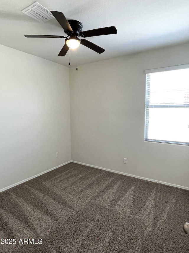 carpeted spare room featuring ceiling fan