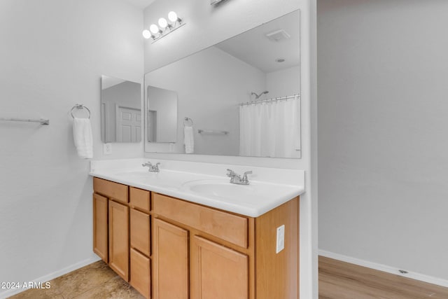 bathroom featuring wood-type flooring, vanity, and walk in shower