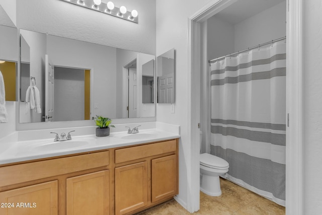 bathroom featuring vanity, curtained shower, and toilet