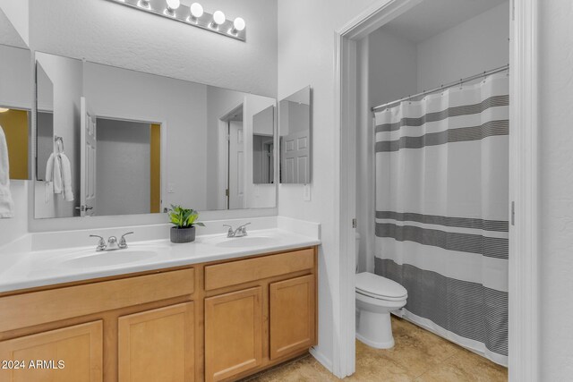 44395 W Bailey Dr, Maricopa, AZ 85138 - bathroom with toilet, double vanity, a shower with shower curtain, and tile patterned floors