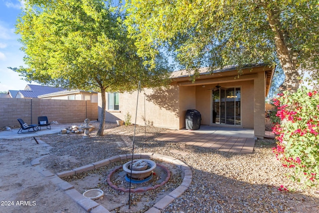 44395 W Bailey Dr, Maricopa, AZ 85138 - back of property featuring an outdoor fire pit, a patio area, stucco siding, and ceiling fan