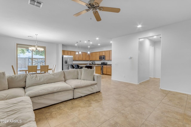44395 W Bailey Dr, Maricopa, AZ 85138 - living area with a chandelier, a ceiling fan, recessed lighting, baseboards, and light tile patterned flooring