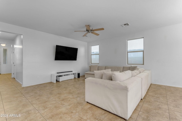 tiled living room featuring ceiling fan