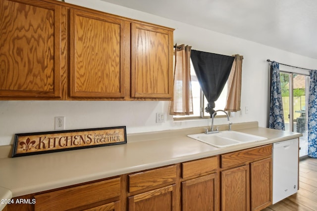 kitchen with sink, light hardwood / wood-style flooring, and white dishwasher