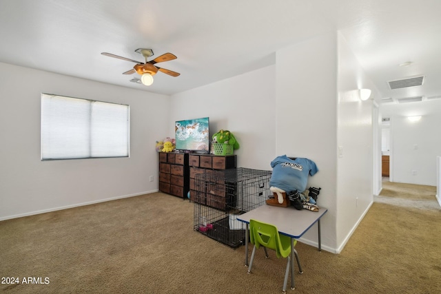 interior space featuring carpet floors, ceiling fan, visible vents, and baseboards