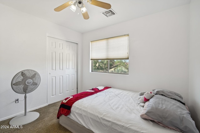 carpeted bedroom with a closet, visible vents, ceiling fan, and baseboards