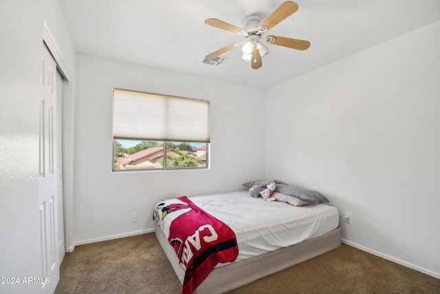 bedroom with carpet floors, a ceiling fan, visible vents, baseboards, and a closet