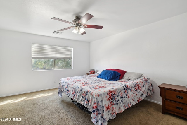 carpeted bedroom with a ceiling fan, visible vents, and baseboards