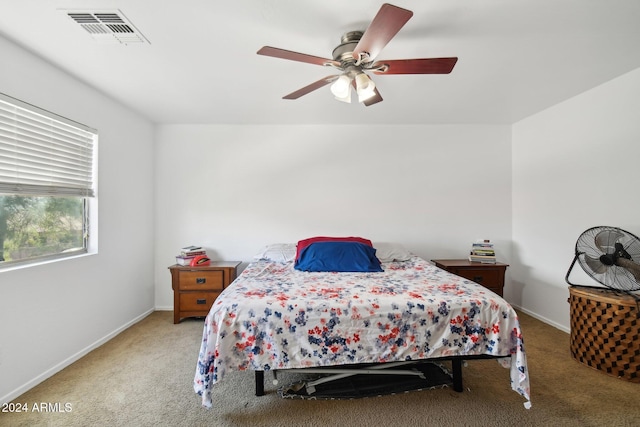 bedroom with carpet floors, a ceiling fan, visible vents, and baseboards