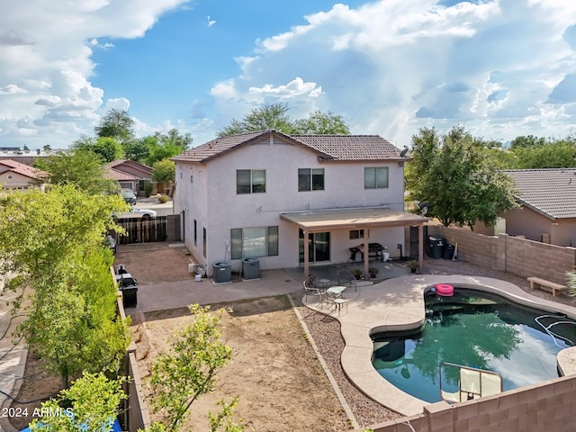 rear view of property with stucco siding, a fenced backyard, a patio, and central air condition unit