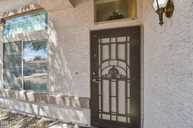 entrance to property featuring stucco siding