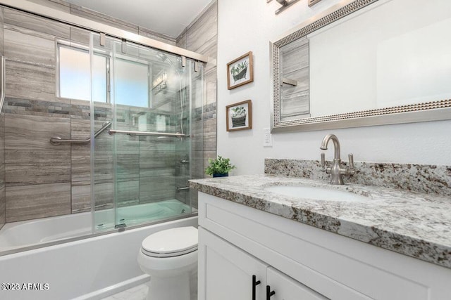 full bathroom with shower / bath combination with glass door, toilet, and vanity