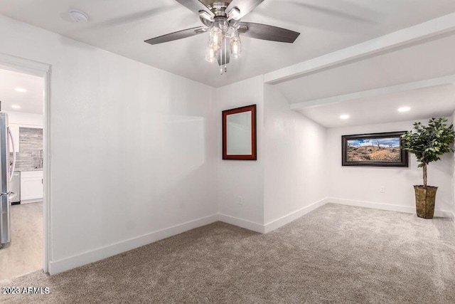 spare room featuring light carpet and ceiling fan