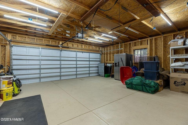 4893 W Big Pine Dr, Lakeside, AZ 85929 - garage featuring fridge with ice dispenser and a garage door opener