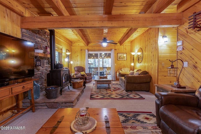 4893 W Big Pine Dr, Lakeside, AZ 85929 - living room featuring a wood stove, wooden ceiling, wood walls, carpet flooring, and beam ceiling