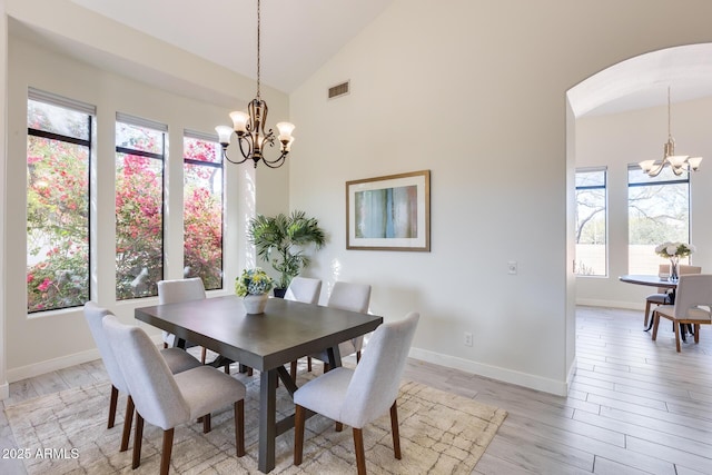 dining area featuring a wealth of natural light, a chandelier, and light hardwood / wood-style floors